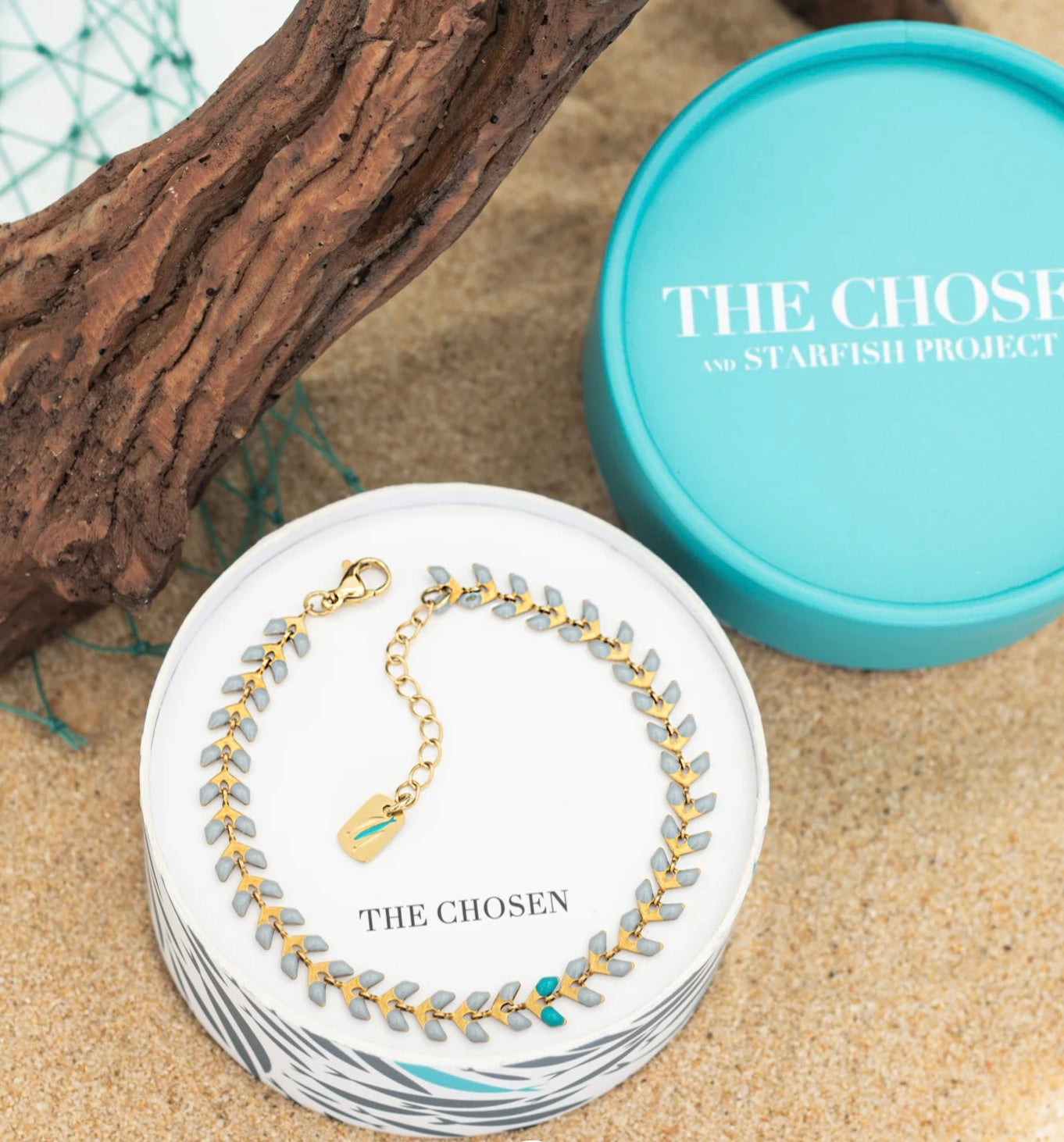 Bracelet on a card with 'The Chosen' branding, next to a turquoise container.