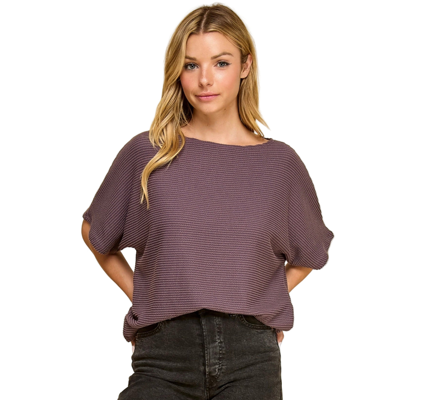 Woman wearing a purple blouse and black pants on a white background
