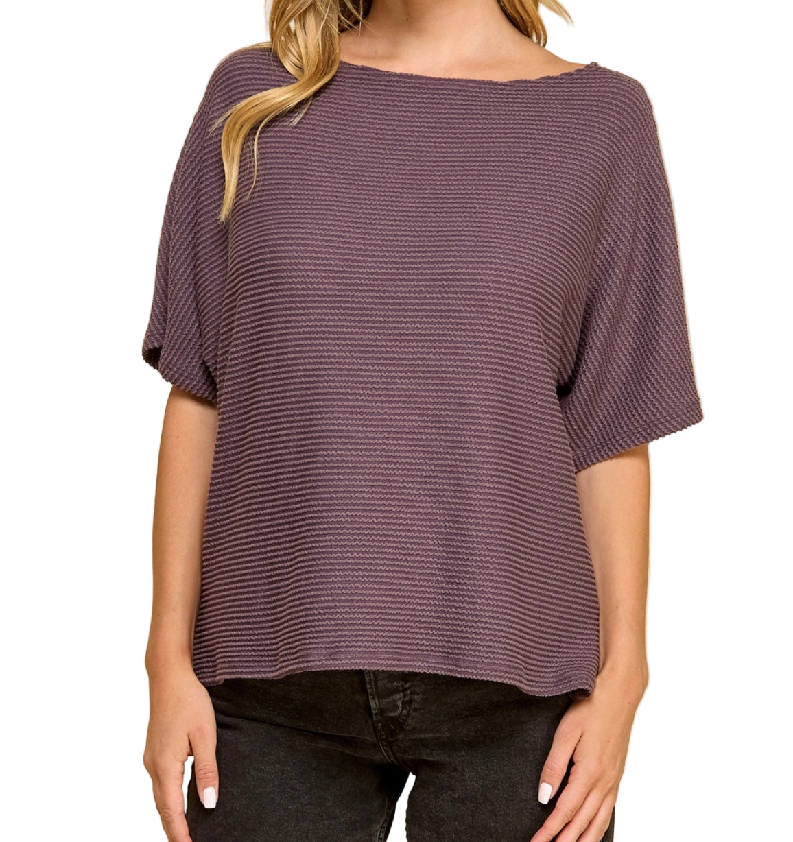 Woman wearing a purple textured top against a white background