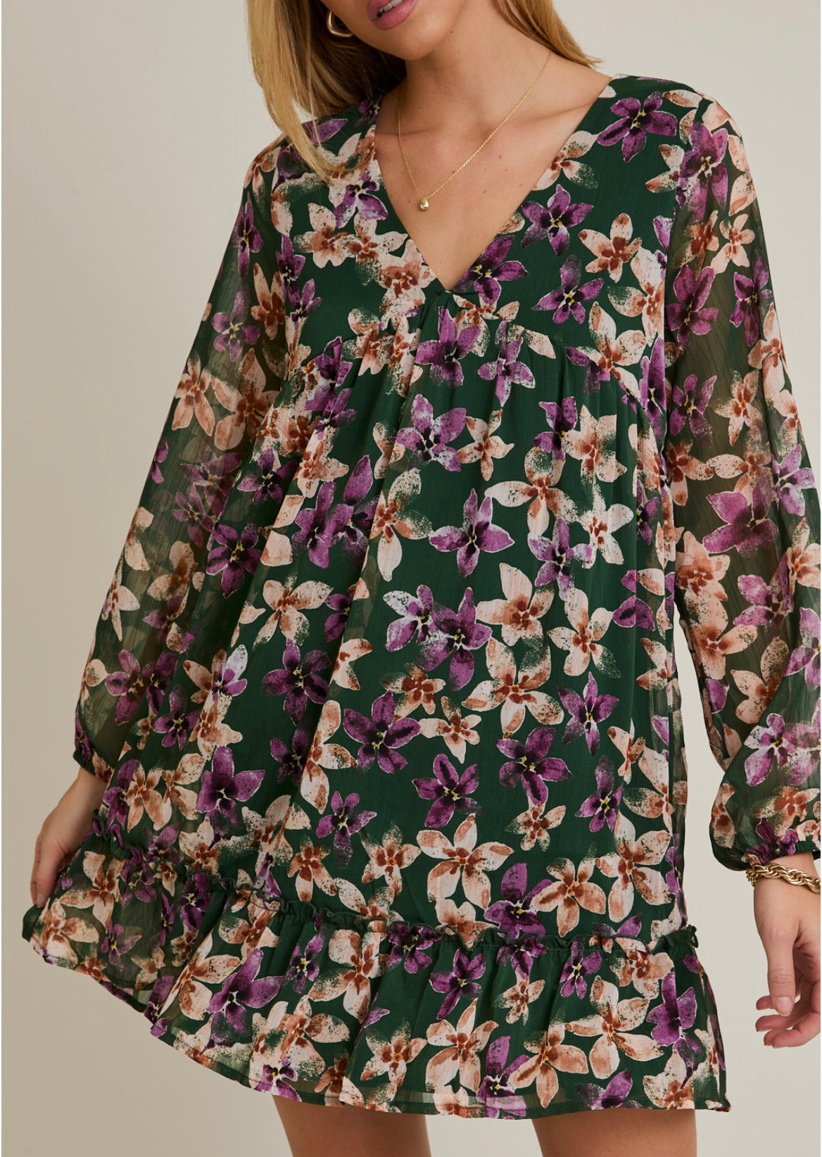 Floral dress with long sleeves on a plain background