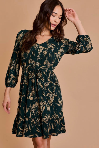 Woman wearing a dark green floral dress against a beige background